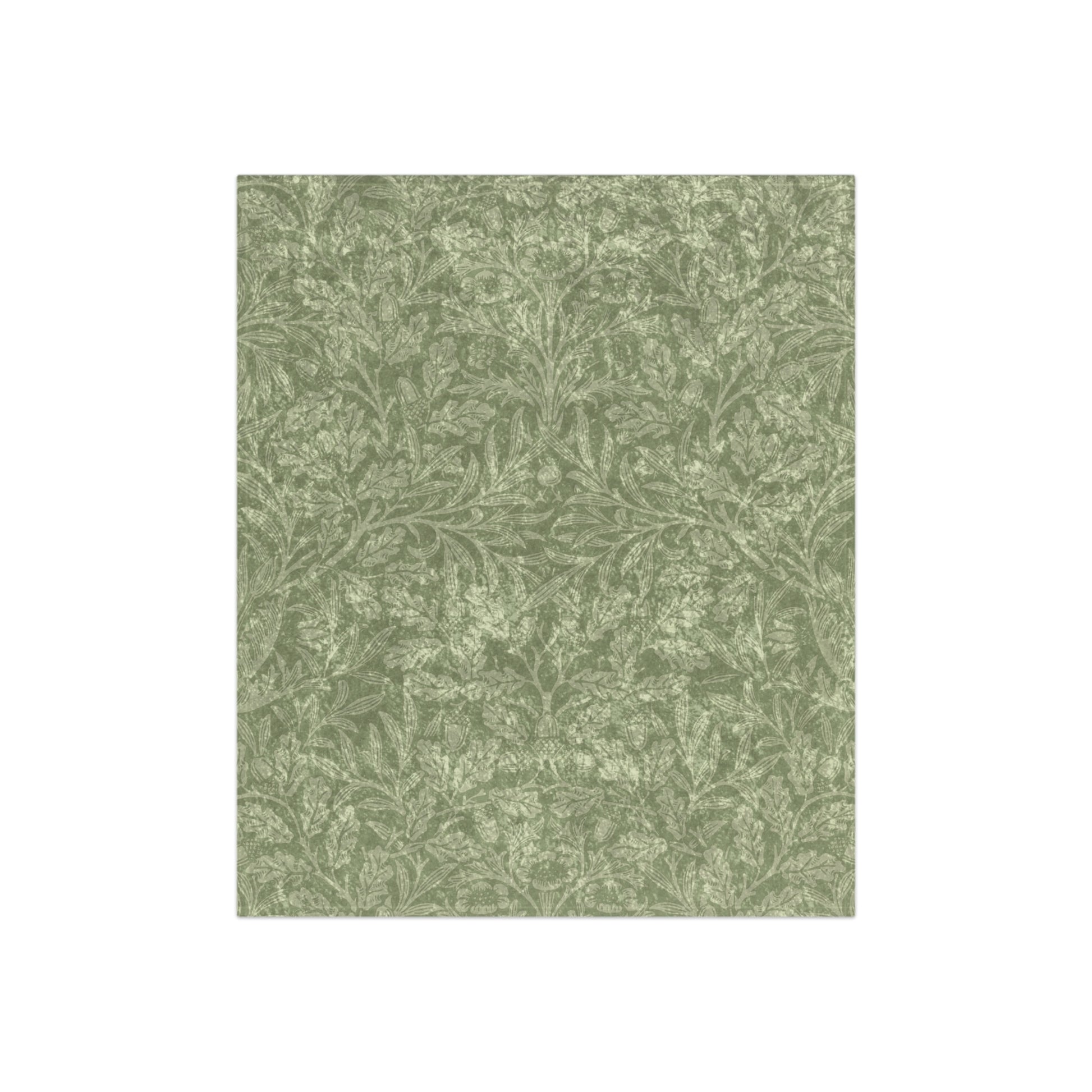 A green crushed velvet blanket with a floral pattern, folded neatly, with the silky reverse side partially visible.
