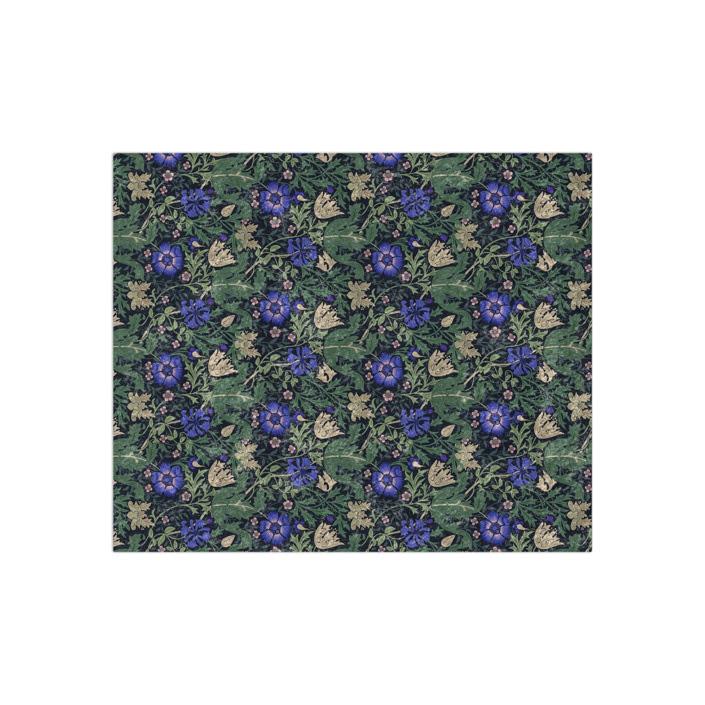 A lush crushed velvet blanket with a floral pattern inspired by William Morris, featuring a bluebell cottage design, displayed folded with the reverse side showing.