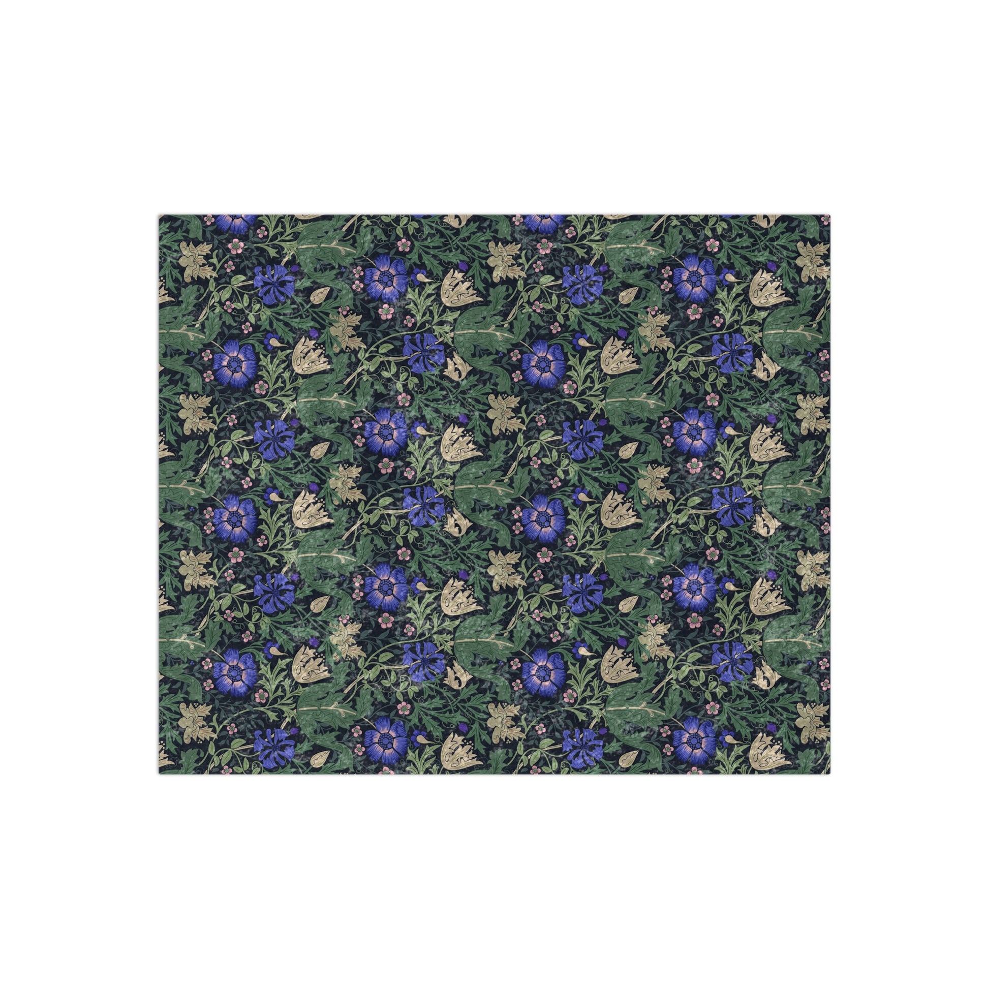 A lush crushed velvet blanket with a floral pattern inspired by William Morris, featuring a bluebell cottage design, displayed folded with the reverse side showing.