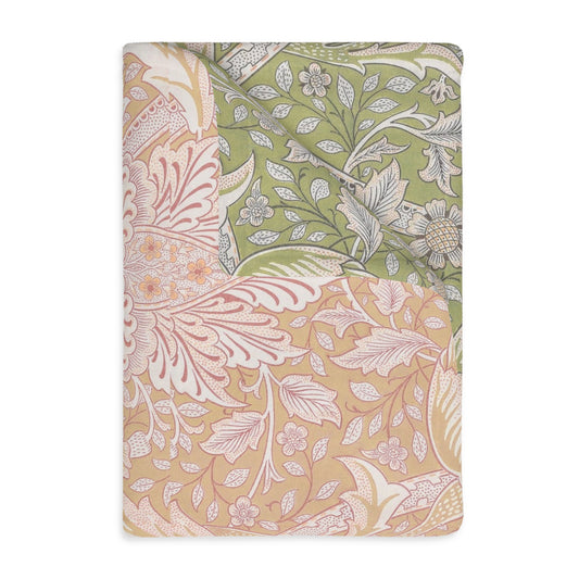 A luxury velveteen minky blanket with a two-sided print featuring floral and leaf designs in green, pink, and beige tones.
