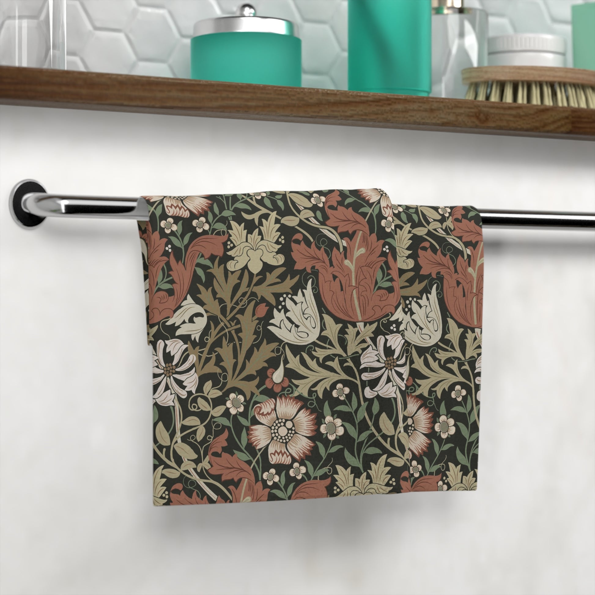 Floral patterned towel hanging on a rack in a bathroom setting.