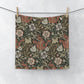 Floral patterned fabric hanging on a line against a white background