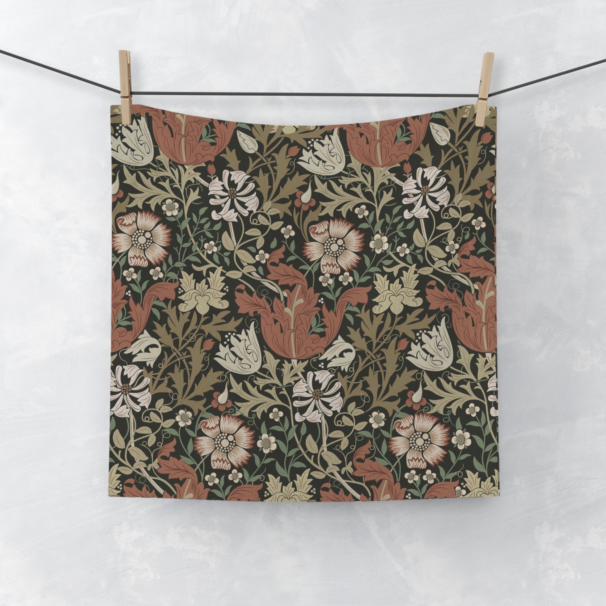 Floral patterned fabric hanging on a line against a white background