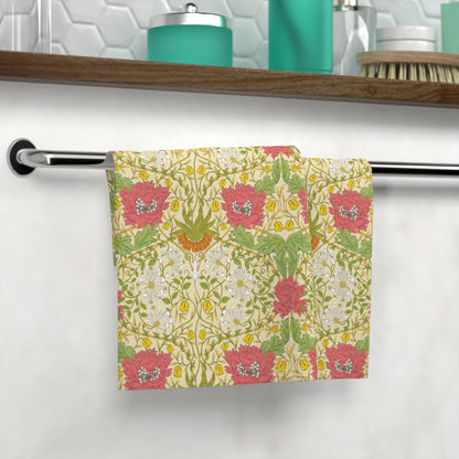 Floral patterned towel hanging on a rack with a bathroom shelf in the background.