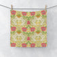 Floral patterned washcloth hanging on a line against a white background