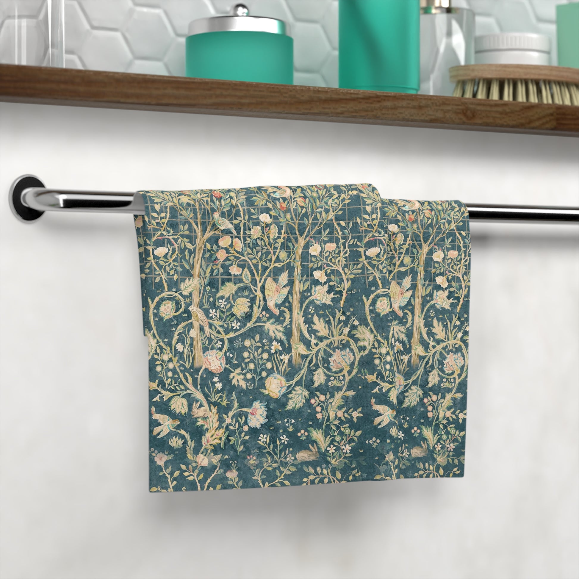 Floral patterned washcloth hanging on a rack in a bathroom setting.