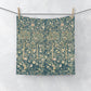 Floral patterned washcloth hanging on a line against a white background