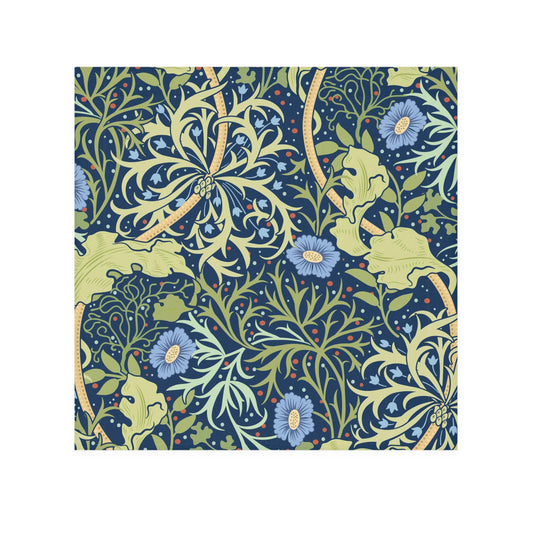 A white washcloth with a floral pattern inspired by William Morris, featuring blue flowers and green leaves on a yellow background.