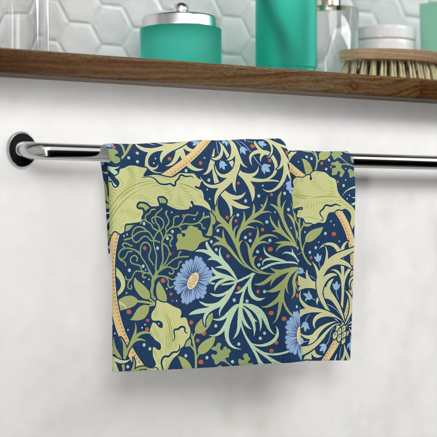 A white washcloth with a floral pattern inspired by William Morris, featuring blue flowers and green leaves on a yellow background.