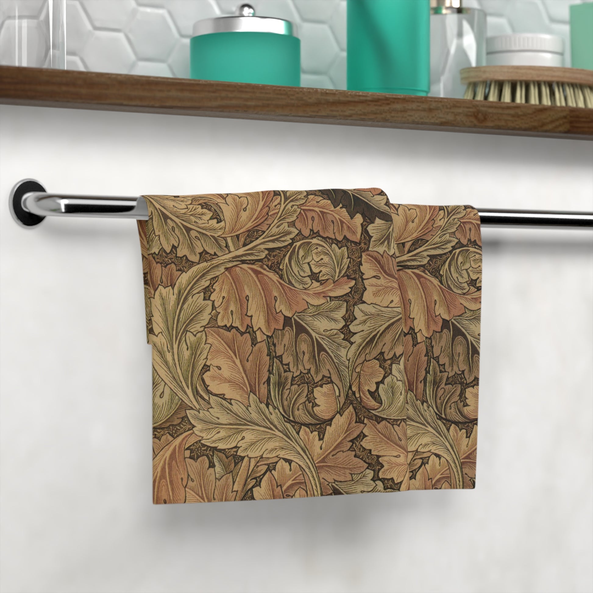 A brown and white washcloth with floral patterns inspired by William Morris, featuring leaves and acanthus designs.