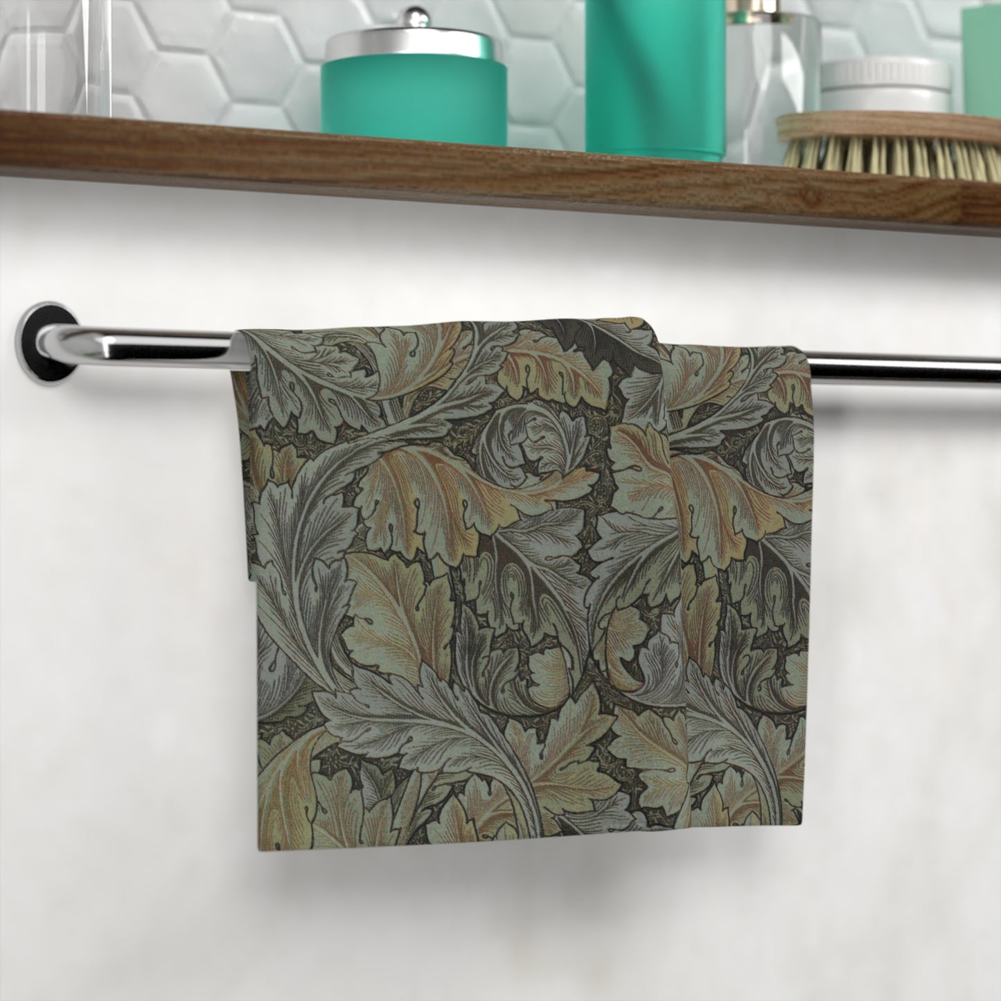 A gray washcloth with floral patterns inspired by William Morris, featuring a mix of leaf and acanthus designs.