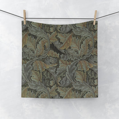 A gray washcloth with floral patterns inspired by William Morris, featuring a mix of leaf and acanthus designs.