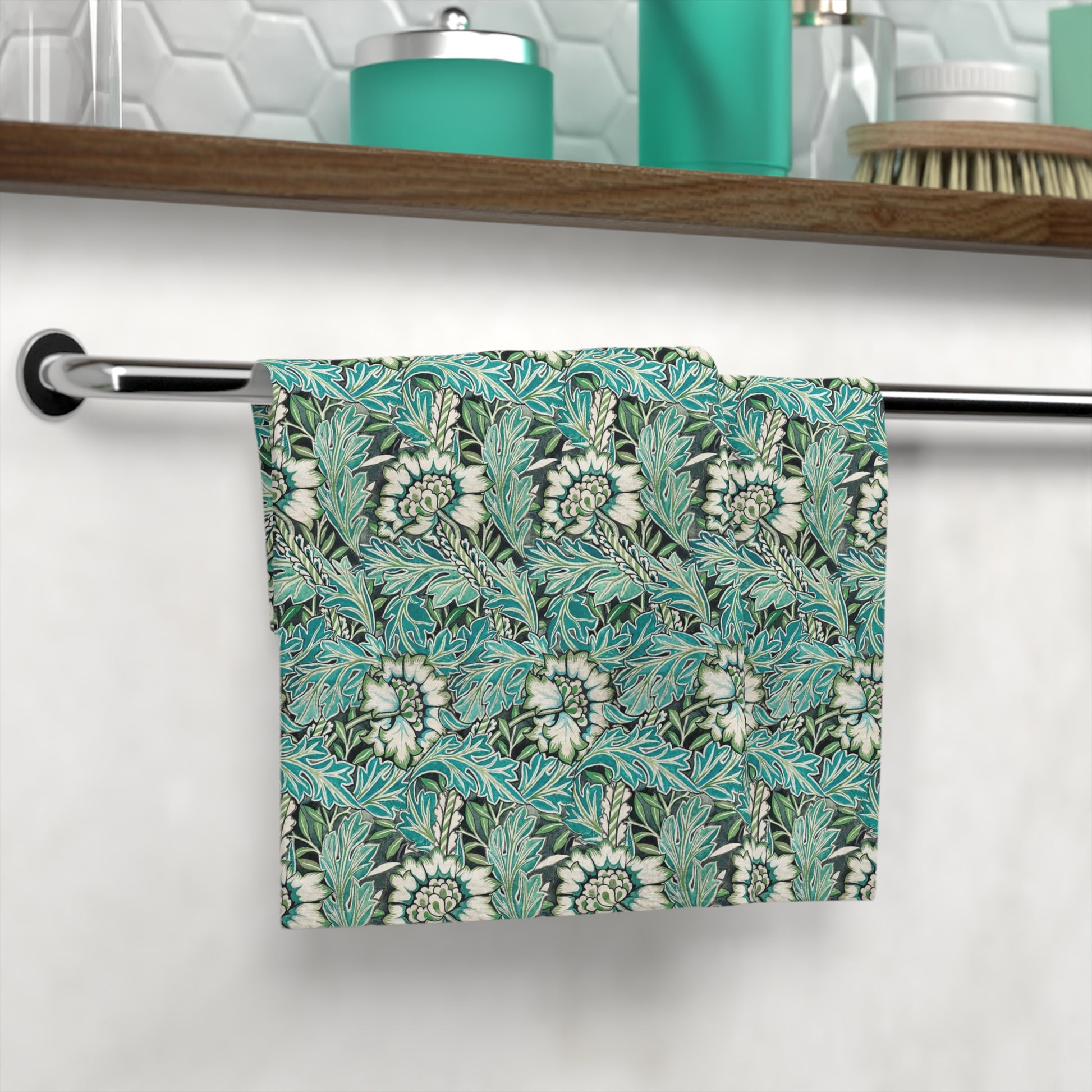 A white washcloth with a floral pattern inspired by William Morris, featuring green and blue colors.
