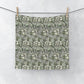 A gray washcloth with a floral pattern inspired by William Morris, featuring a design with leaves and anemone flowers.