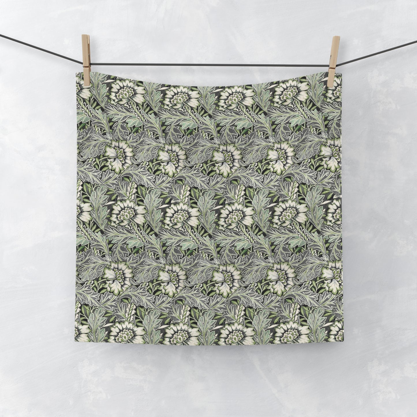 A gray washcloth with a floral pattern inspired by William Morris, featuring a design with leaves and anemone flowers.