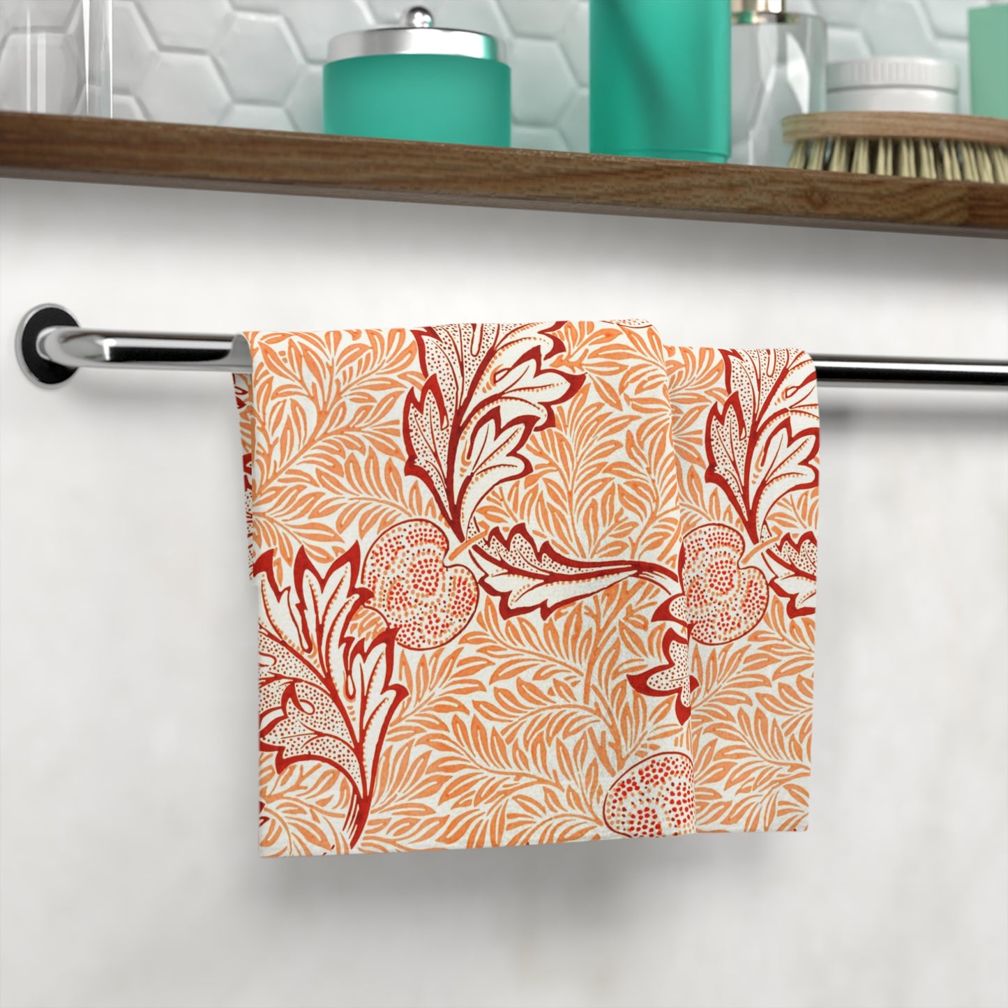 Washcloth with red floral pattern hanging on a rack in a bathroom.