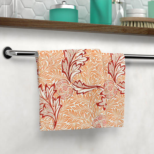 Washcloth with red floral pattern hanging on a rack in a bathroom.