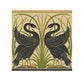Decorative tile with two black swans and green foliage on a beige background