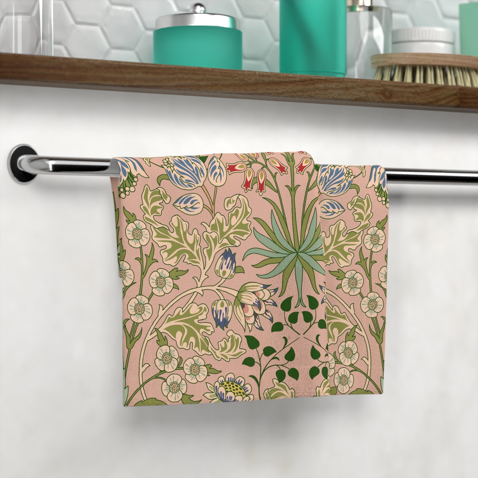 Decorative towel with floral pattern hanging on a rack in a bathroom.