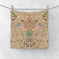 Floral patterned washcloth hanging on a line against a white background