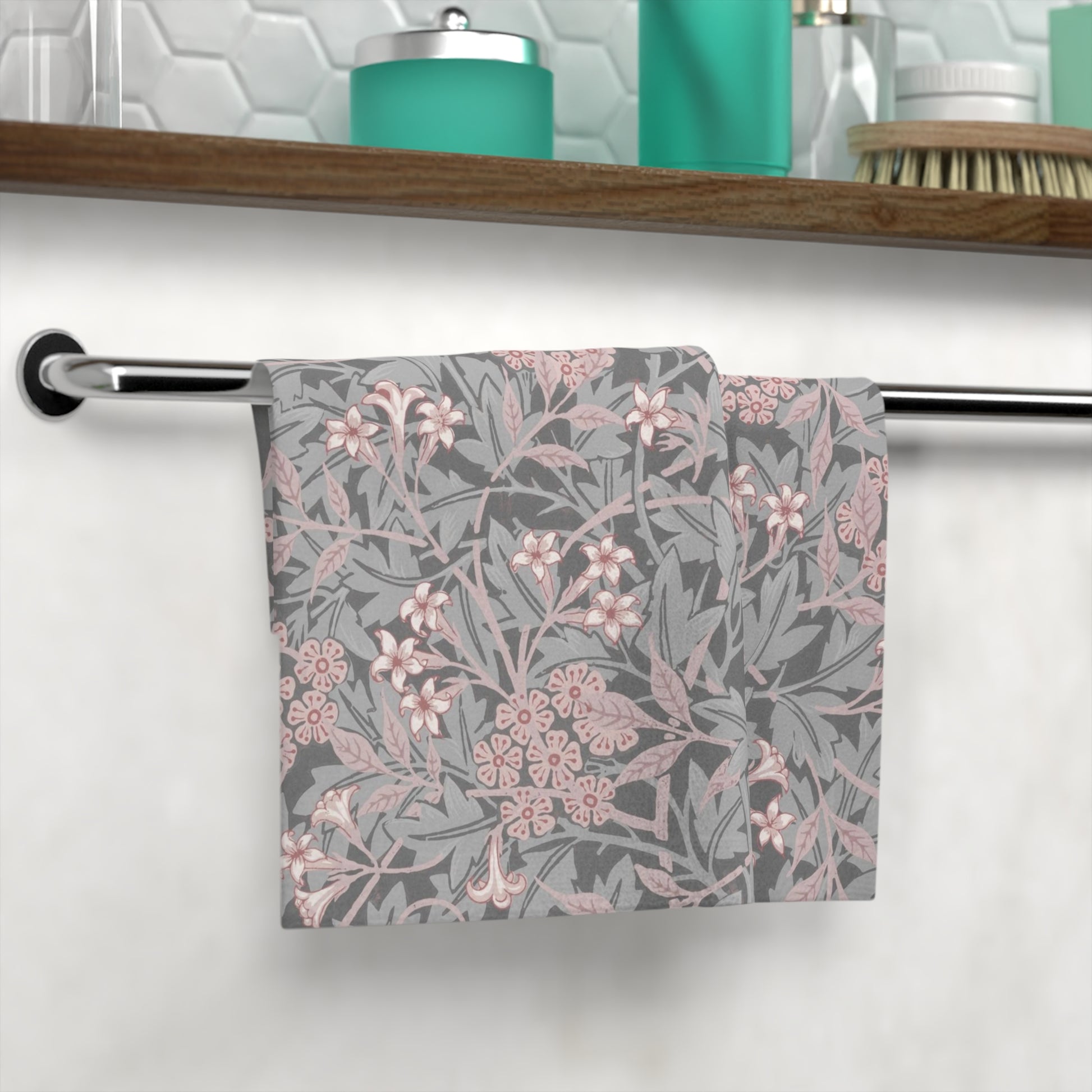 A square-shaped washcloth with a floral pattern in mauve and gray colors, inspired by William Morris' design.