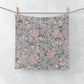 A square-shaped washcloth with a floral pattern in mauve and gray colours, inspired by William Morris' design.