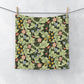Floral patterned washcloth hanging on a line against a white background