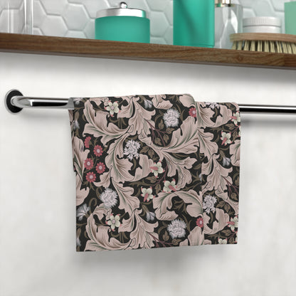 Floral patterned towel hanging on a rack with a bathroom setting in the background.