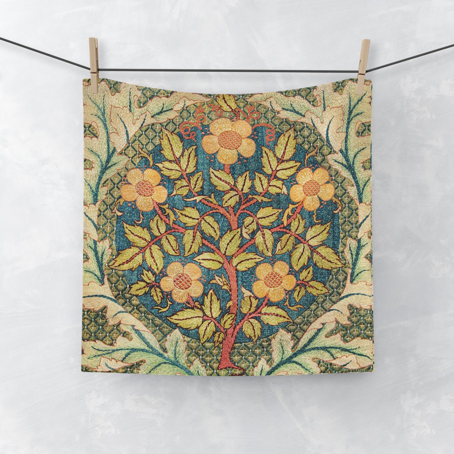 Floral patterned fabric hanging on a line against a white background