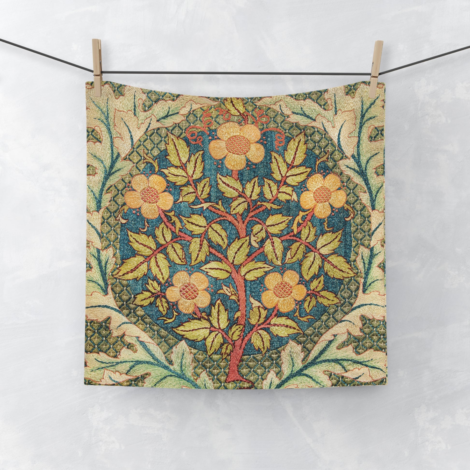 Floral patterned fabric hanging on a line against a white background