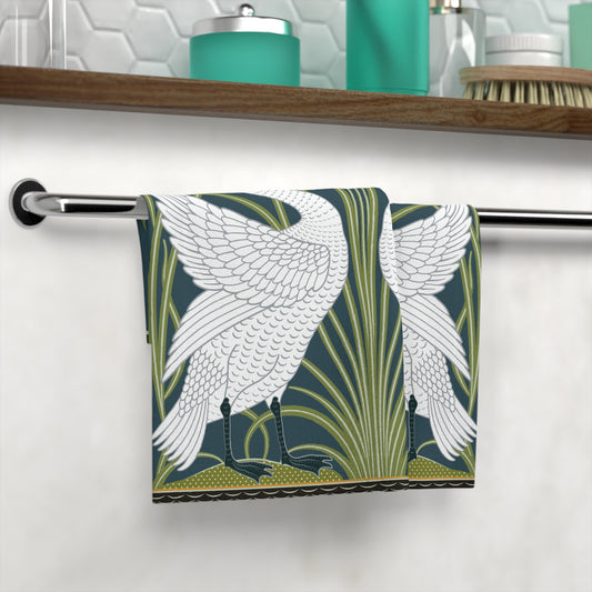 Towel with bird and plant design hanging on a rack in a bathroom setting.