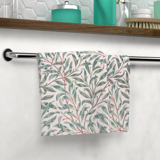 Towel with leaf pattern hanging on a rack in a bathroom setting