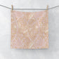 Floral patterned washcloth hanging on a wire with a white background