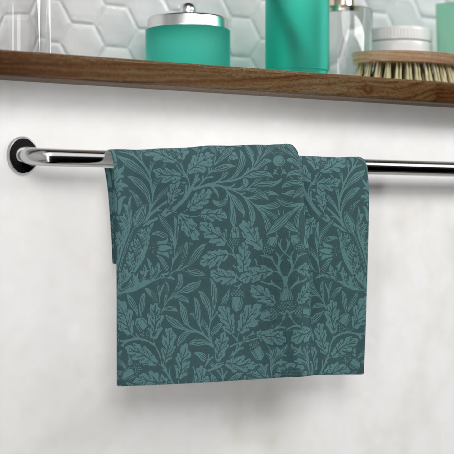 A square-shaped washcloth with a floral pattern in a teal colour, inspired by William Morris' Acorns & Oak Leaves Collection.