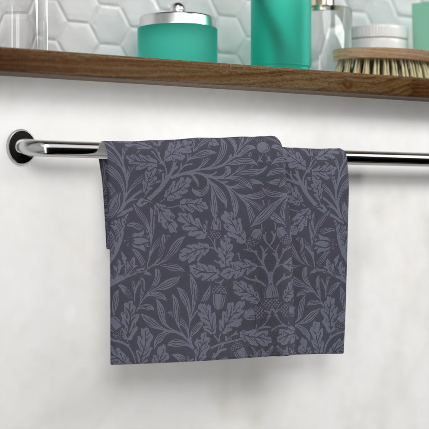 A smoky blue washcloth with a floral pattern inspired by William Morris's design, featuring acorns and oak leaves.
