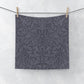 A smoky blue washcloth with a floral pattern inspired by William Morris's design, featuring acorns and oak leaves.