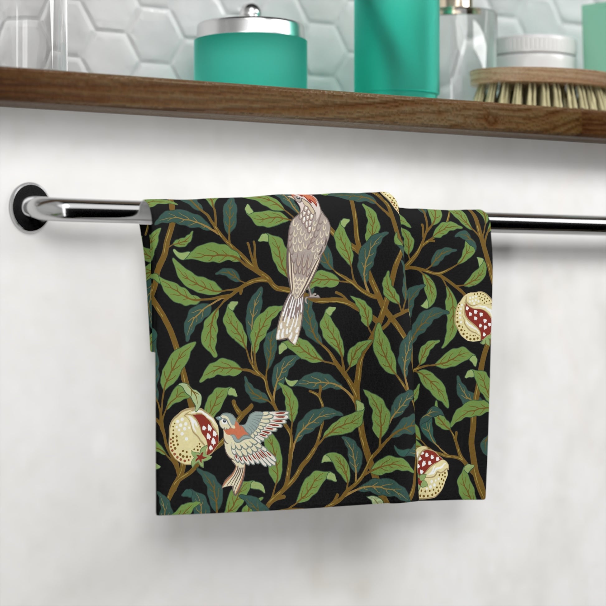 A white washcloth with a floral pattern featuring birds and pomegranates, inspired by the William Morris design.