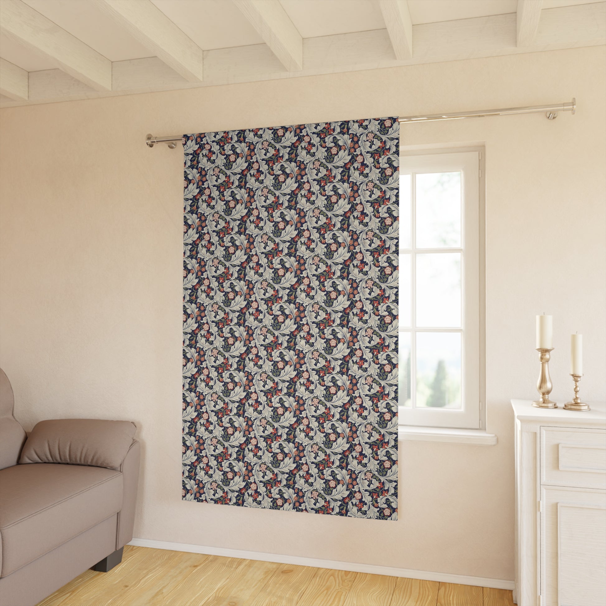 Floral patterned curtain hanging in a room with a sofa and window.