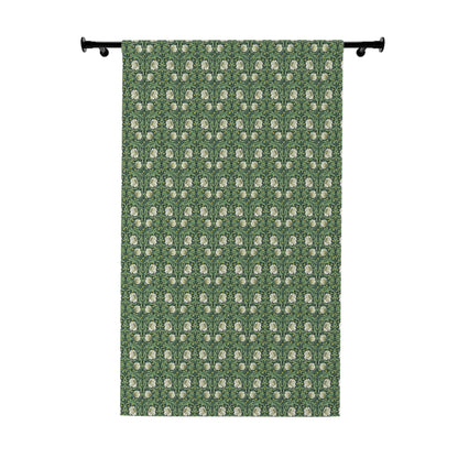 Green curtain with white floral pattern on a white background