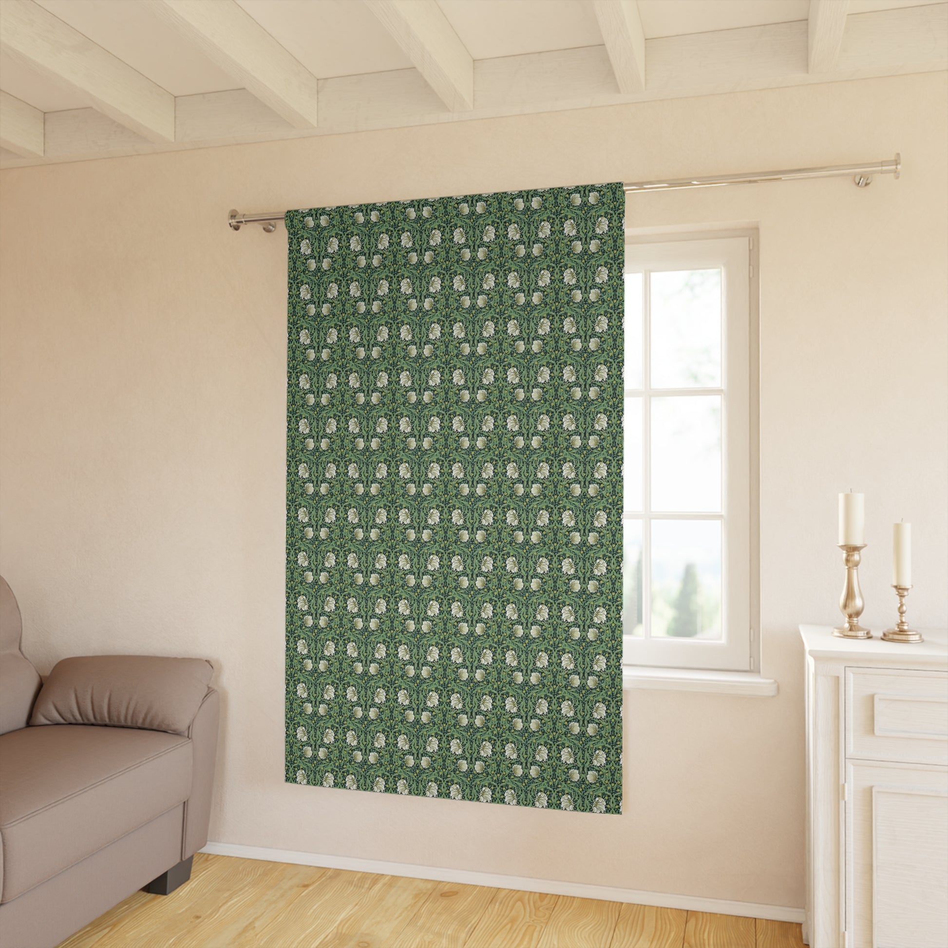 Green patterned curtain hanging in a room with a sofa and window.