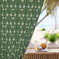 Green floral patterned fabric with a beach scene featuring coconuts on a table.