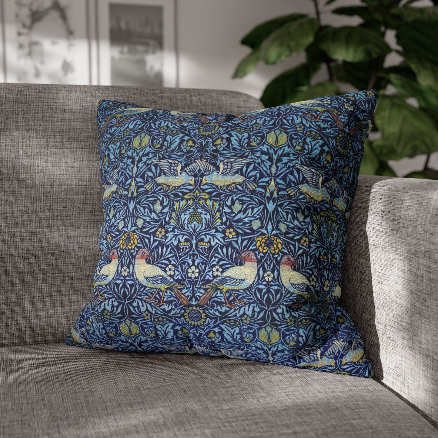 Decorative pillow with floral and bird pattern on a gray sofa