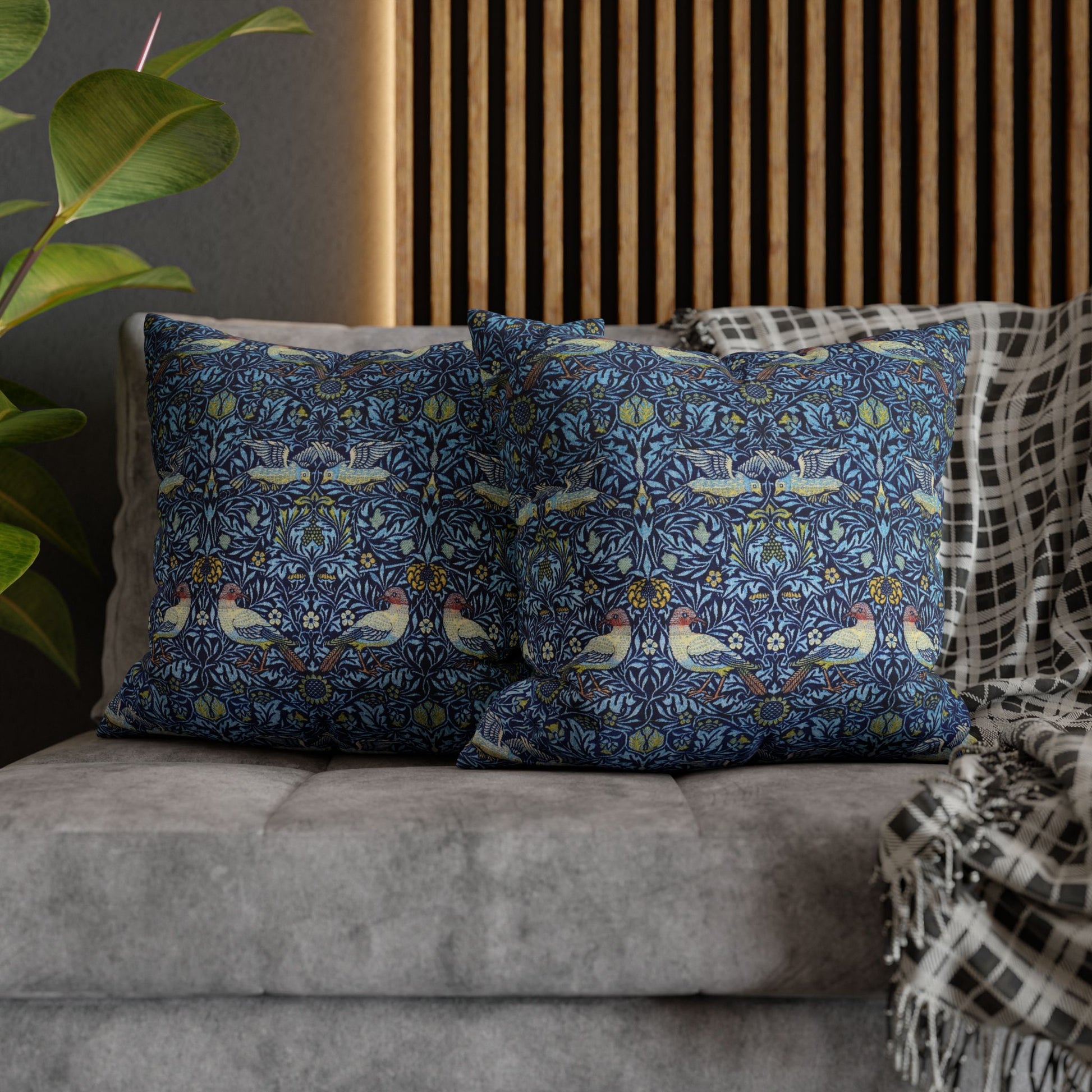 Decorative pillows with a floral pattern on a gray sofa.