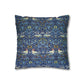 Decorative pillow with a blue pattern featuring birds and floral elements on a white background