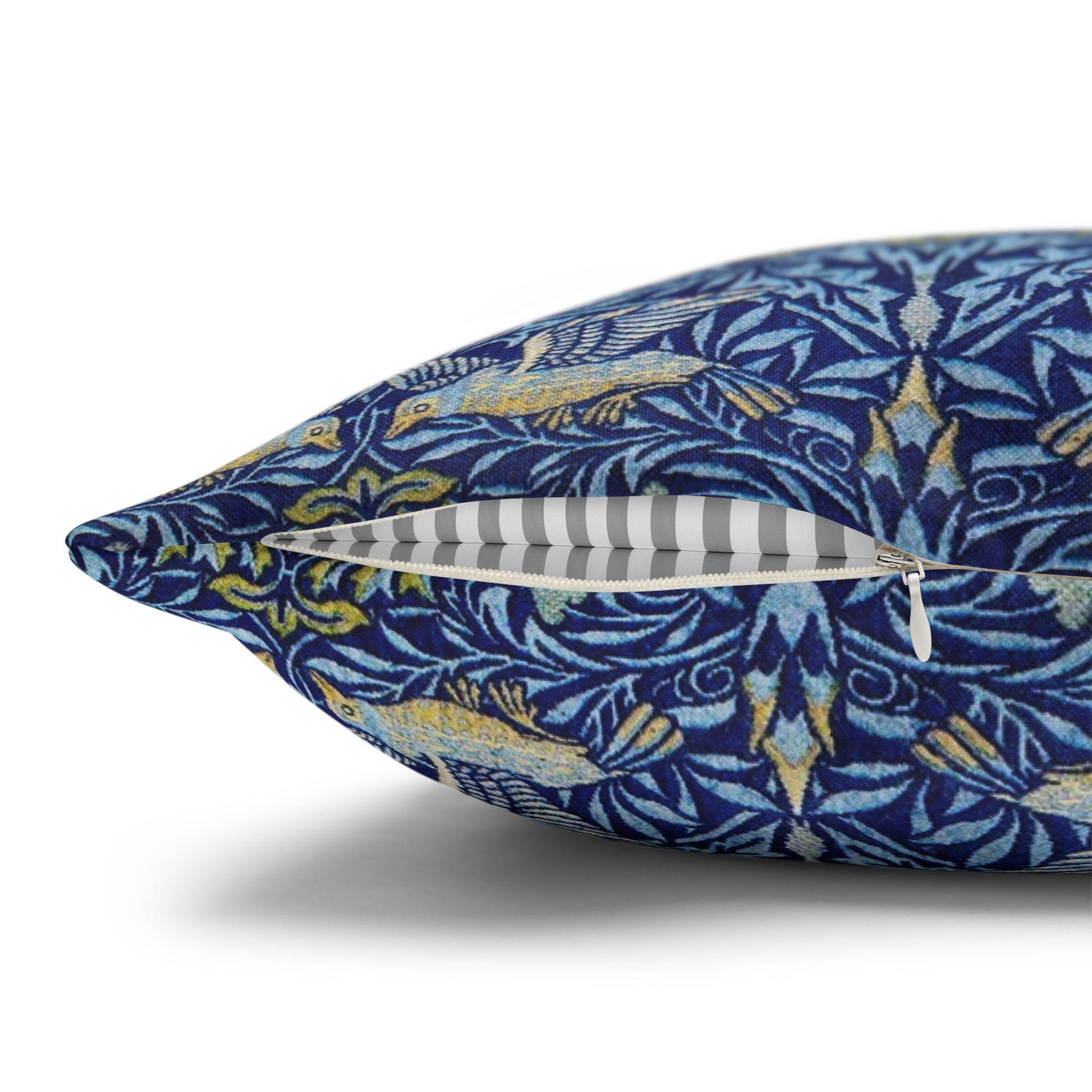 Decorative pillow with blue and yellow pattern on a white background