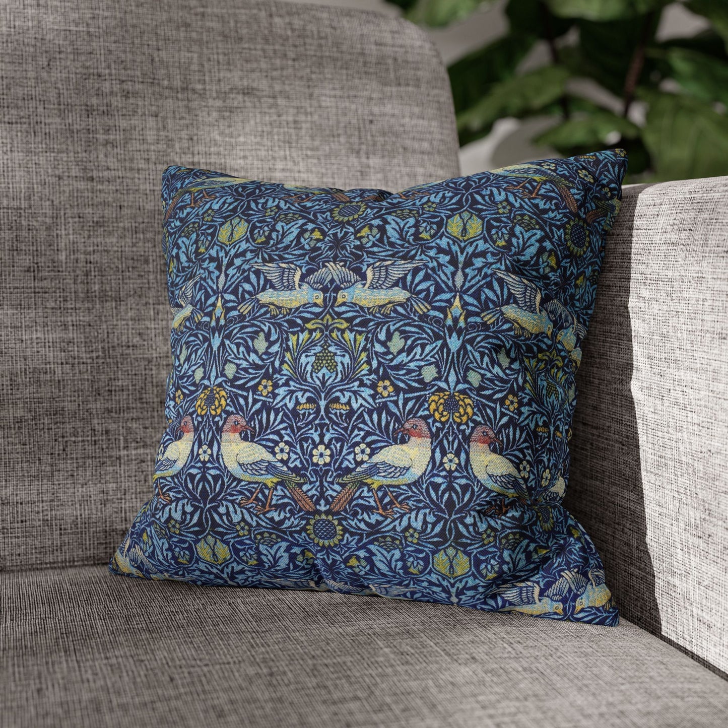 Decorative pillow with bird pattern on a gray sofa