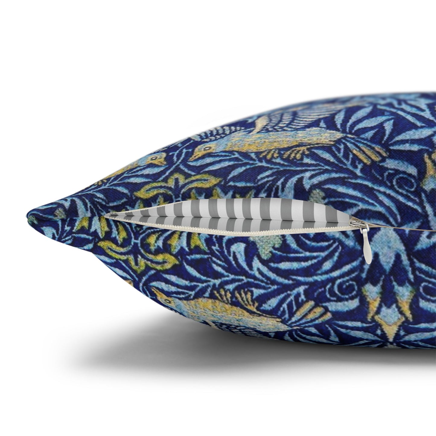 Blue floral-patterned pillow with a zipper on a white background