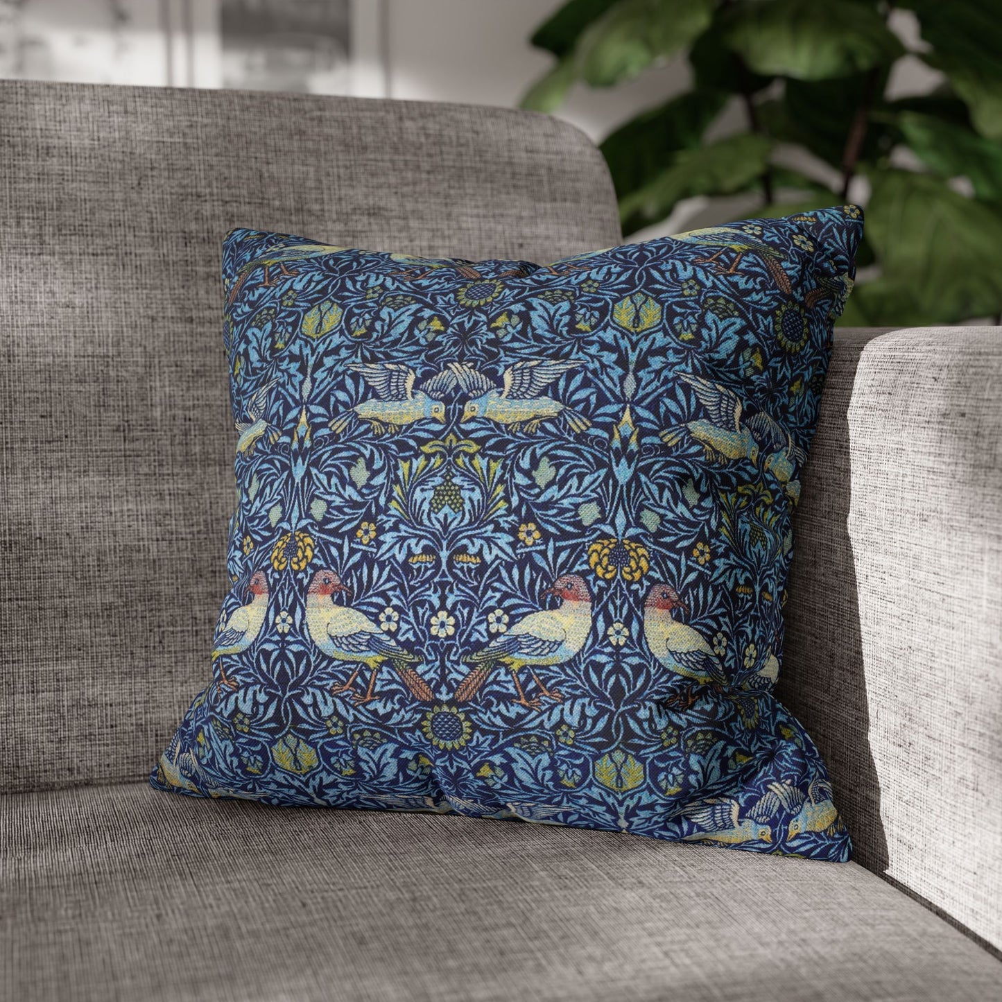 Decorative pillow with bird pattern on a gray sofa