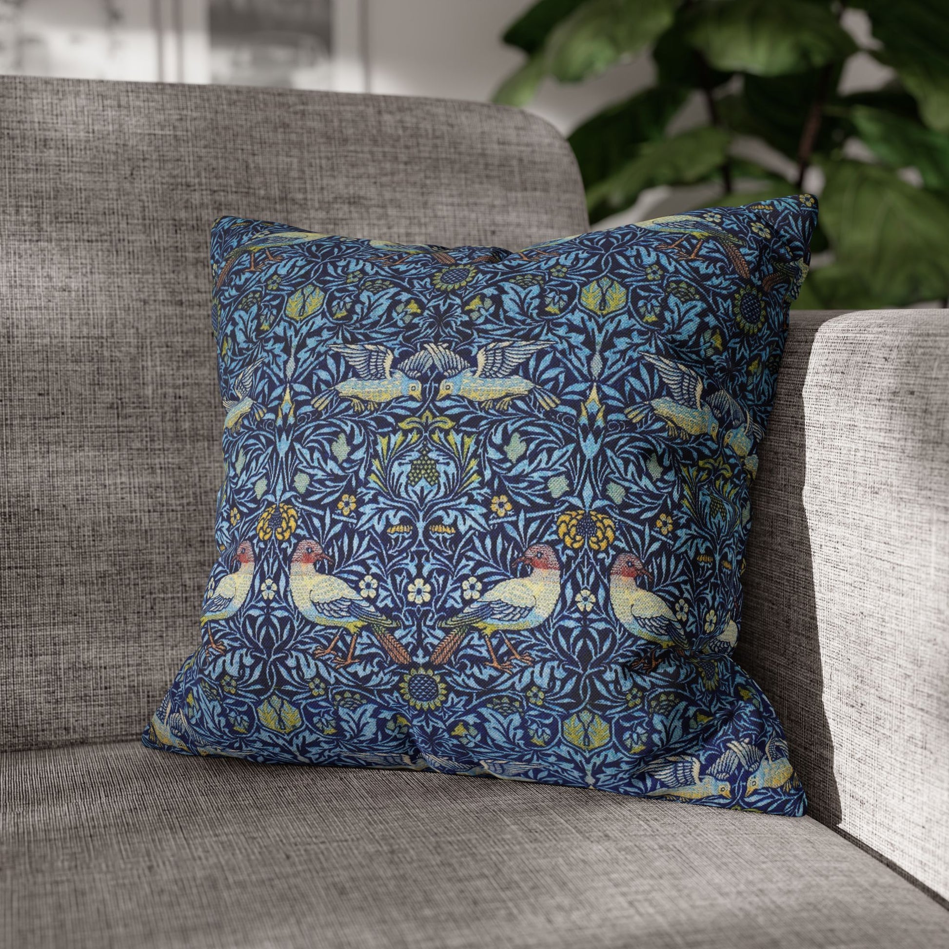 Decorative pillow with bird pattern on a gray sofa
