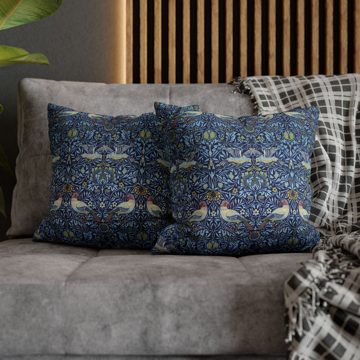 Decorative pillows with a floral pattern on a gray sofa.
